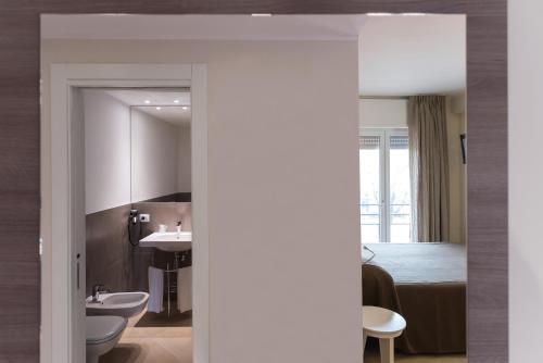 a bathroom with a sink and a bed in a room at Guesthouse Verona in Verona