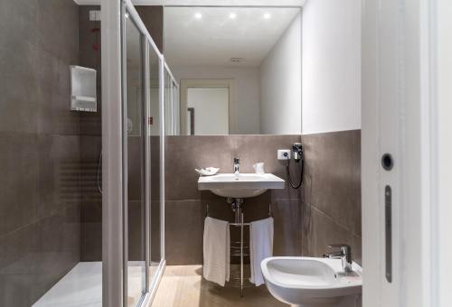 a bathroom with a sink and a glass shower at Guesthouse Verona in Verona