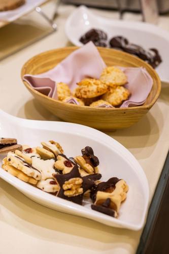 a plate of food on a table with a bowl of desserts at Urban Suites Recoleta Boutique Hotel in Buenos Aires