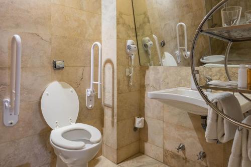 a bathroom with a toilet and a sink at Urban Suites Recoleta Boutique Hotel in Buenos Aires