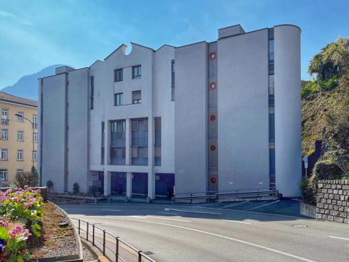 a white building on the side of a road at Bilocale con terrazzi Via Antonio Riva 3 by LR in Lugano