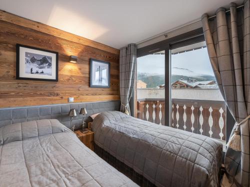 a bedroom with two beds and a window at Spacieux appartement moderne, skis aux pieds à Courchevel - FR-1-563-94 in Courchevel