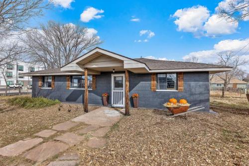 a blue house with a basket of oranges in front of it at Grand Canyon Ranch Home - Western History - Big city lot - AC! in Williams