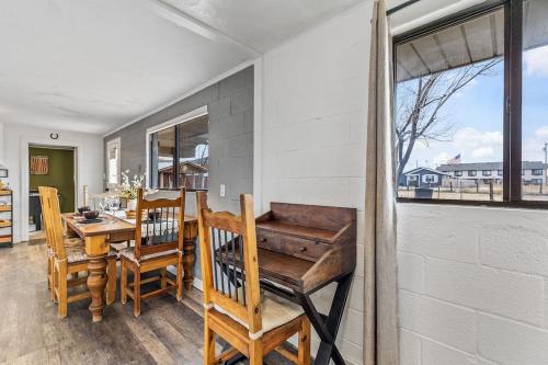 a dining room with a table and chairs and a window at Grand Canyon Ranch Home - Western History - Big city lot - AC! in Williams