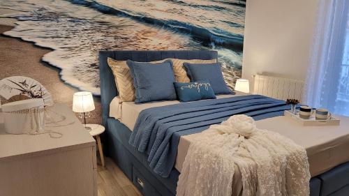 a bedroom with a bed with a painting of the ocean at Apartment Lidija in Krk