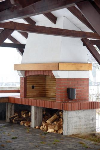 a brick oven sitting on top of a pile of wood at Villa Bjelolasica in Jasenak
