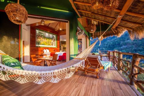 a hammock on the porch of a house at Villa Lala Boutique Hotel Adults Only in Puerto Vallarta