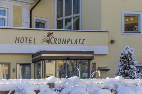 a hotel with snow on the ground in front of a building at Hotel Kronplatz in Valdaora