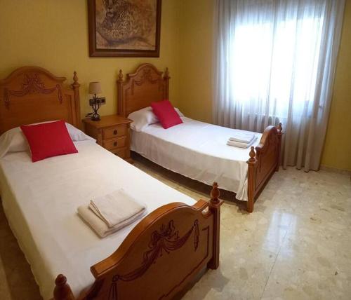 a bedroom with two beds and a window at casa con piscina privada in Vinarós