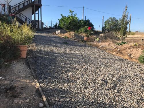 a gravel road leading up to a house at Eco Lodge Loro Tuerto in Guanaqueros