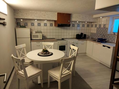a kitchen with a table and chairs in a kitchen at Ferienwohnung CoCo in Haltern