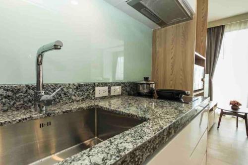 a kitchen with a large stainless steel sink at Diamond Resort Phuket Bangtao in Phuket