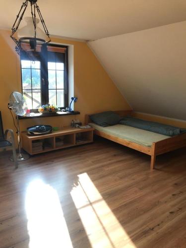 a attic room with a bed and a window at Dom Nad Jeziorem Łąkorz in Łąkorz