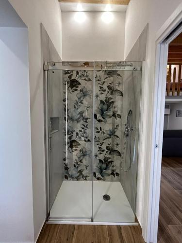 a shower with a glass door in a room at LA FORMICA APARTMENT in Agrigento