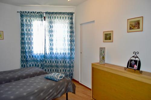 a bedroom with a bed and a window at Il lago e la collina in Stresa