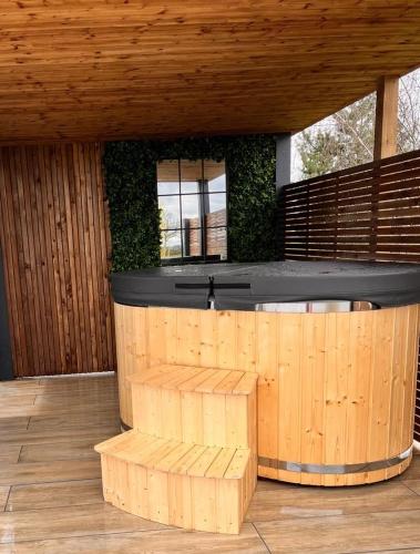 a wooden bar with a bench in front of it at New Farm Cheshire Holidays in Winsford