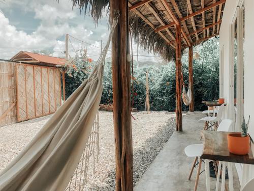 a hammock in a house with a patio at Ayampe Lofts in Ayampe