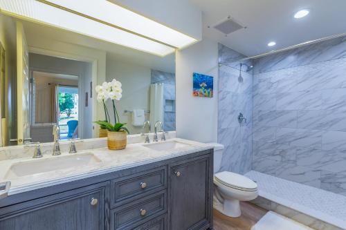 a bathroom with a sink and a toilet and a shower at Emmalani Court 414 in Princeville