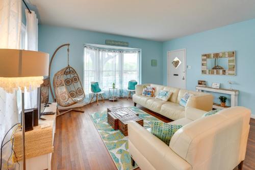a living room with blue walls and a white couch at Vintage Corpus Christi Home - 2 Blocks From Beach! in Corpus Christi