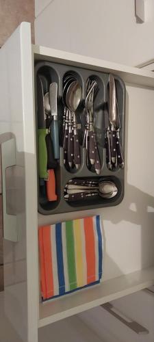 a drawer filled with utensils in a cabinet at Νώε in Perístasis