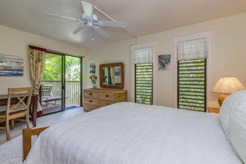 a bedroom with a bed and a ceiling fan at Waikomo Streams 121 in Koloa