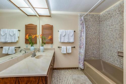 a bathroom with a sink and a tub and a shower at Waikomo Streams 121 in Koloa