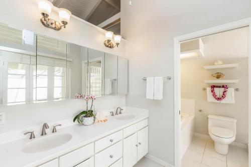 a white bathroom with a sink and a toilet at Mala Hale in Princeville