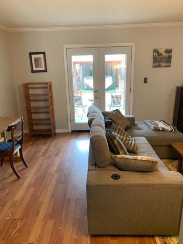 a living room with a couch and a table at Creek View Townhome in Augusta