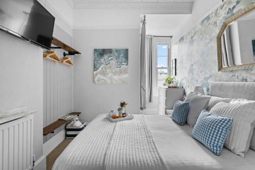 a living room with a bed and a tv at Sandway House in Torquay