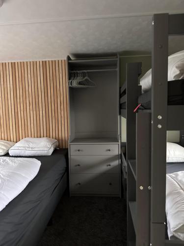 sypialnia z 2 łóżkami piętrowymi i szafą w obiekcie Retro Stacaravan w mieście Warmond