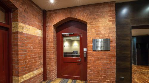 a brick wall with a door in a building at InterContinental Melbourne The Rialto by IHG in Melbourne