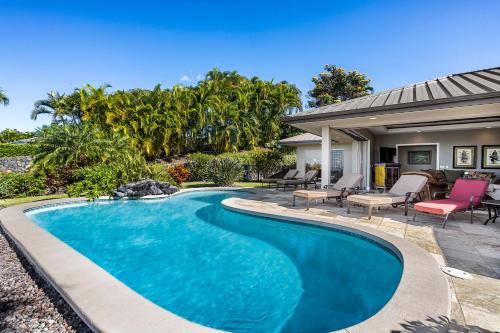 a swimming pool in the backyard of a house at Hale Aikane in Kailua-Kona
