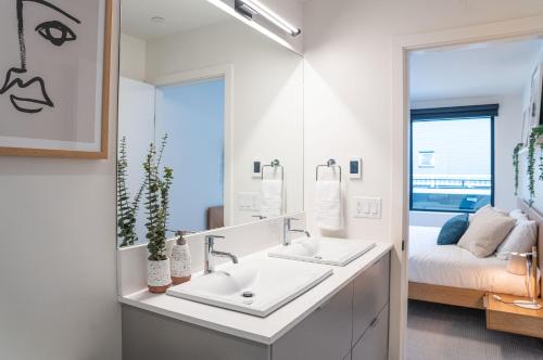 a bathroom with two sinks and a mirror at Adanac by Revelstoke Vacations in Revelstoke