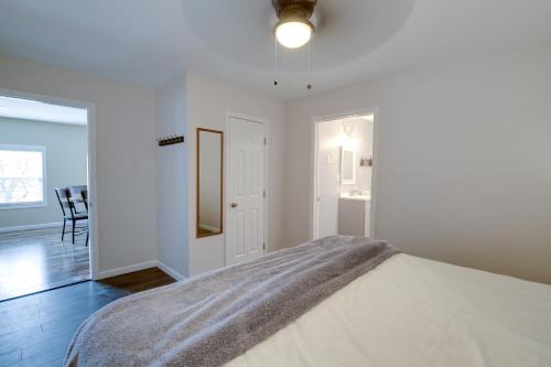 a white bedroom with a bed and a mirror at Dandridge Vacation Rental with Fishing Pier and Grill! in Dandridge