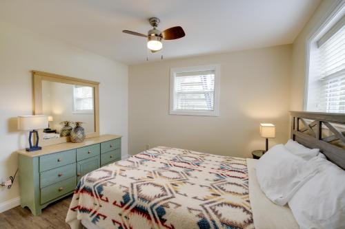 a bedroom with a bed and a dresser and a mirror at Dandridge Vacation Rental with Fishing Pier and Grill! in Dandridge