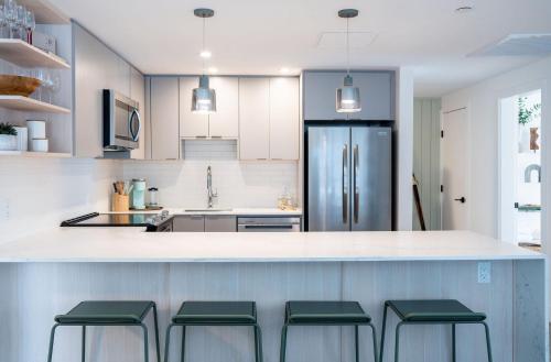 a kitchen with a counter with four stools at Adanac by Revelstoke Vacations in Revelstoke