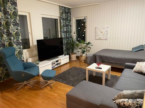 a living room with a couch and a flat screen tv at Studiohuoneisto Valtakatu 45, sauna, AC, WiFi in Lappeenranta