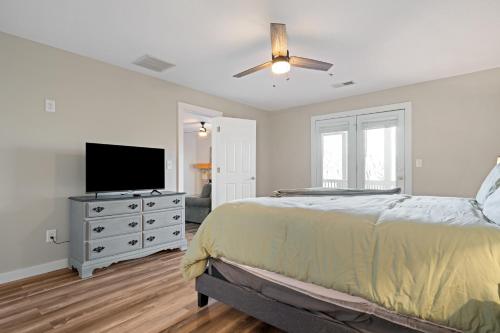 a bedroom with a bed and a flat screen tv at Nacoochee in Helen