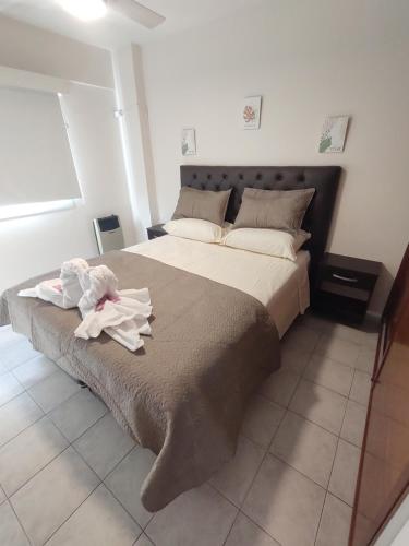 a bedroom with a large bed with towels on it at Sweet Suite Home GOLD in Córdoba