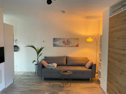 a living room with a couch and a table at Ferienwohnung Sternenhimmel in Lichtenberg