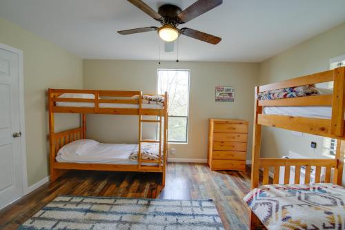 a bedroom with two bunk beds and a ceiling fan at Dandridge Vacation Rental with Fishing Pier and Grill! in Dandridge
