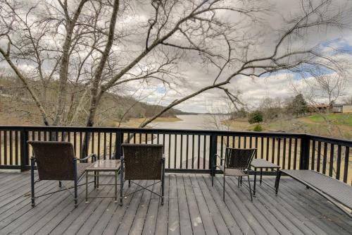 three chairs and tables on a deck with a view of a river at Dandridge Vacation Rental with Fishing Pier and Grill! in Dandridge