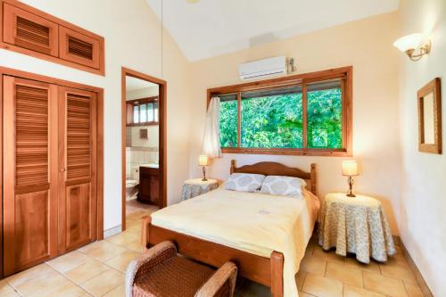 a bedroom with a bed and a window at Punta Studio at Framadani Estate in San Ignacio