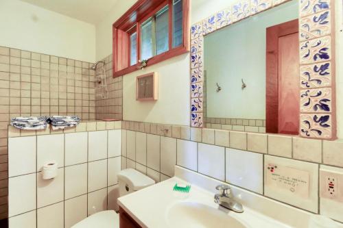 a bathroom with a sink and a toilet and a mirror at Punta Studio at Framadani Estate in San Ignacio