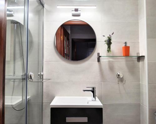a bathroom with a sink and a mirror at Casa la Juncara in Guarnizo