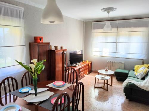 a living room with a table and a dining room at Casa la Juncara in Guarnizo