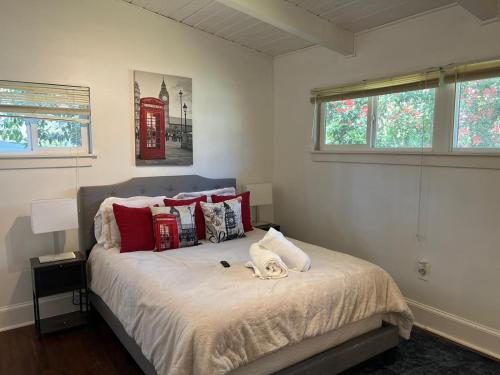 a bedroom with a bed with red pillows and a telephone booth at Recently renovated Haven in Brookhaven. in Atlanta