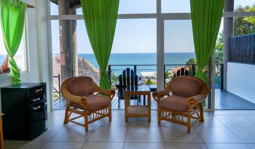 a living room with a view of the ocean at Kayu Surf Resort in La Libertad