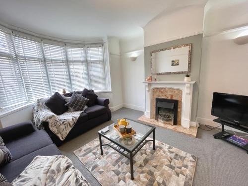 a living room with a couch and a fireplace at City Haven Luxurious 3-Bed Retreat in Portsmouth