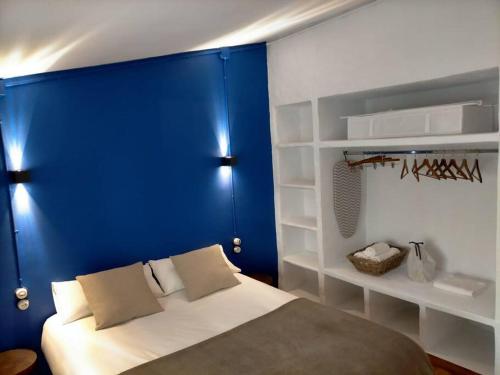um quarto com uma parede azul e uma cama em Bonito y céntrico apartamento casco antiguo em Tarragona